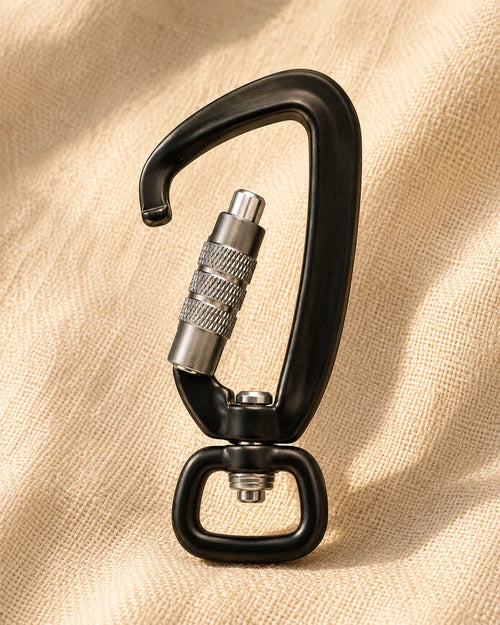 The Latch in matte black with brushed aluminum screw-lock gate on warm cream linen background